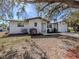 Charming single-story home with white stucco exterior, manicured landscaping, and an attached one car garage at 388 Flamingo Dr, Venice, FL 34285