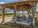 Shaded community gazebo with picnic tables offering beach views and outdoor seating at 388 Flamingo Dr, Venice, FL 34285