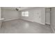 Neutral living room features tile flooring, a ceiling fan, and large windows for natural light at 388 Flamingo Dr, Venice, FL 34285