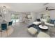 Open-concept living space featuring modern light fixture, sleek furniture, and sliding glass doors to a pool at 388 Flamingo Dr, Venice, FL 34285