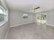 Bright living area features sliding glass doors, large windows and neutral wall colors at 388 Flamingo Dr, Venice, FL 34285