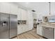 Bright kitchen with stainless steel appliances, white cabinetry and decorative backsplash at 394 Hanchey Dr, Nokomis, FL 34275