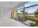 Tile patio showcases a peaceful lake view framed by palm trees and clear sliding glass doors at 406 Cerromar N Cir # 123, Venice, FL 34293