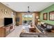 Spacious living room with neutral flooring, ceiling fan, and sliding glass doors to the outdoor patio at 4285 Lenox Blvd, Venice, FL 34293