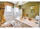Bathroom with a large vanity, tub and shower combo, and decorated in earth tones at 4398 Summertree Rd, Venice, FL 34293