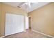 Bedroom with tile flooring, ceiling fan, large closet, and view of the attached bathroom at 4398 Summertree Rd, Venice, FL 34293