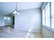 Dining area featuring a modern chandelier, plantation shutters, and an open layout at 4398 Summertree Rd, Venice, FL 34293