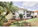Charming home exterior with manicured lawn, shrubs and screened-in lanai at 4398 Summertree Rd, Venice, FL 34293