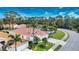 Charming home with a tile roof, manicured lawn, and a paved driveway, complemented by mature trees at 4398 Summertree Rd, Venice, FL 34293