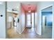 Hallway view showcasing tile floors, stylish lighting, and glimpses into the kitchen and an adjacent room at 4398 Summertree Rd, Venice, FL 34293
