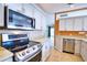 The kitchen showcases modern stainless steel appliances, granite countertops, and white cabinetry at 4398 Summertree Rd, Venice, FL 34293