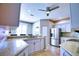 Well-lit kitchen featuring modern stainless steel appliances, granite countertops, and stylish cabinetry at 4398 Summertree Rd, Venice, FL 34293