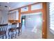 Open kitchen featuring a breakfast bar with granite countertops and stylish seating overlooking the dining area at 4398 Summertree Rd, Venice, FL 34293