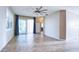 Spacious living area with tile flooring, a ceiling fan, and sliding glass doors that let in natural light at 4398 Summertree Rd, Venice, FL 34293