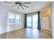 Living area with a ceiling fan, tile floors and sliding glass doors to the back yard at 4398 Summertree Rd, Venice, FL 34293
