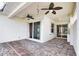 Covered patio with ceiling fans, brick flooring and access via sliding glass doors at 4398 Summertree Rd, Venice, FL 34293