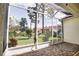 Screened lanai with brick flooring and view of landscaped backyard at 4398 Summertree Rd, Venice, FL 34293
