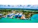 Aerial view of waterfront property featuring boat storage and docks, set amidst beautiful scenery at 471 Bayshore Rd, Nokomis, FL 34275