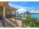 Back of the home with outdoor pool, patio and waterway access with dock at 471 Bayshore Rd, Nokomis, FL 34275
