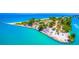 Panoramic aerial view of a sandy peninsula surrounded by clear, turquoise water at 471 Bayshore Rd, Nokomis, FL 34275