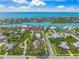 Expansive aerial view of a residential area with waterfront homes and lush landscaping near the ocean at 471 Bayshore Rd, Nokomis, FL 34275