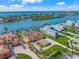 Aerial view of a grand waterfront estate featuring lush landscaping and serene water views at 471 Bayshore Rd, Nokomis, FL 34275