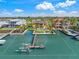 Aerial view of waterfront home with lush landscaping, canal access and boat lift at 471 Bayshore Rd, Nokomis, FL 34275