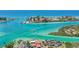 Stunning aerial view of waterfront homes with boats cruising along crystal-clear waters at 471 Bayshore Rd, Nokomis, FL 34275