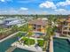 Aerial view of a beautiful property featuring a pool, waterfront access, and lush landscaping at 471 Bayshore Rd, Nokomis, FL 34275