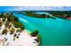 Aerial view of a tranquil beach and waterway, perfect for boating and relaxation at 471 Bayshore Rd, Nokomis, FL 34275