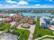 Stunning aerial view of waterfront homes with lush landscaping and private docks on a sunny day at 471 Bayshore Rd, Nokomis, FL 34275