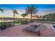 Relaxing backyard oasis featuring lounge chairs, beautiful water views, and lush greenery at 471 Bayshore Rd, Nokomis, FL 34275