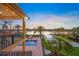 Backyard view featuring a pool, waterfront access, and tropical landscaping at 471 Bayshore Rd, Nokomis, FL 34275