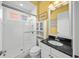 Bathroom featuring a glass-enclosed shower, black granite countertop, and modern fixtures at 471 Bayshore Rd, Nokomis, FL 34275