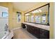 Bathroom with a large mirror, double vanity, and a separate shower and bathtub at 471 Bayshore Rd, Nokomis, FL 34275