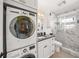 Modern bathroom featuring a sleek vanity, glass shower, and convenient washer/dryer at 471 Bayshore Rd, Nokomis, FL 34275