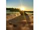 A seashell sits on a sandy beach as the sun sets over the ocean at 471 Bayshore Rd, Nokomis, FL 34275