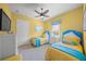 Shared bedroom with twin beds, yellow and blue covers, and a ceiling fan at 471 Bayshore Rd, Nokomis, FL 34275