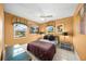 Comfortable bedroom featuring a queen size bed, tile floors, and natural light at 471 Bayshore Rd, Nokomis, FL 34275