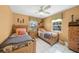 Bright bedroom with two twin beds, tile floors, and windows that offer a serene view at 471 Bayshore Rd, Nokomis, FL 34275