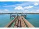 Beautiful view of the waterfront with a private dock and blue skies overhead at 471 Bayshore Rd, Nokomis, FL 34275