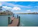 Inviting view of the waterfront with a dock, bench seating, and calm blue waters at 471 Bayshore Rd, Nokomis, FL 34275