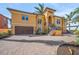 Elegant home with two-car garage, staircase to the entry way and brick paved circular driveway at 471 Bayshore Rd, Nokomis, FL 34275