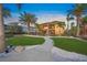 Beautiful two-story home with tile roof, lush landscaping and walkway at 471 Bayshore Rd, Nokomis, FL 34275