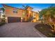 Elegant two-story home boasts a brick driveway, two-car garage, and tropical landscaping at 471 Bayshore Rd, Nokomis, FL 34275