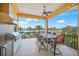 Covered patio with an outdoor kitchen, seating and views of the waterfront at 471 Bayshore Rd, Nokomis, FL 34275