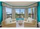 Cozy sitting area with comfortable sofas and views of the water at 471 Bayshore Rd, Nokomis, FL 34275
