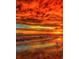 Ocean sunset featuring a vibrant sky reflected in the wet sand with gentle waves at 471 Bayshore Rd, Nokomis, FL 34275