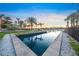 Beautiful waterfront canal with views of tropical palm trees and landscaped yard at 471 Bayshore Rd, Nokomis, FL 34275