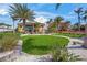 Lush landscaped yard with manicured lawn, palm trees, and a pathway leading to a beautiful home at 471 Bayshore Rd, Nokomis, FL 34275